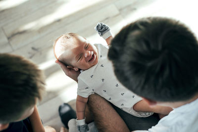 Father playing with children at home