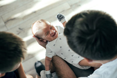 Boy holding father with son