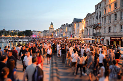 Group of people walking on street in city