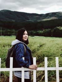 Portrait of woman sitting on field