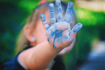 Close-up of blue colored hand