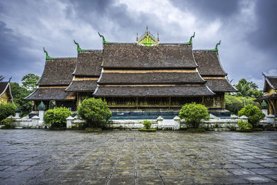 Footpath by temple against sky