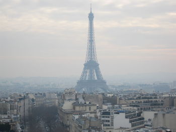 Low angle view of eiffel tower amidst buildings in city