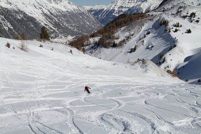 Person skiing on snowcapped mountain