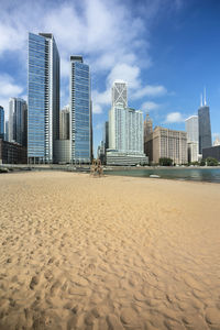 View of beach and buildings against sky