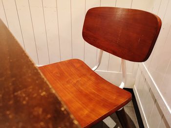 High angle view of empty chair on table at home