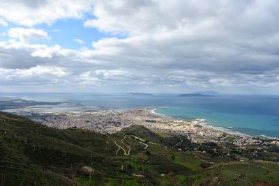 High angle view of townscape by sea against sky