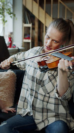 Midsection of woman playing violin