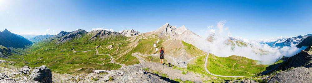 Rear view of woman with mountains in background