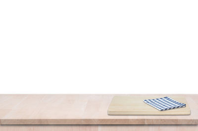 Close-up of paper on table against white background