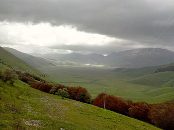 Scenic view of mountains against cloudy sky