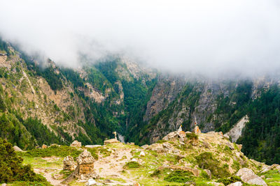 Scenic view of landscape against foggy weather