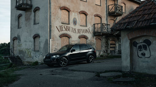 Car on street amidst buildings