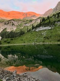 Scenic view of lake and mountains against sky