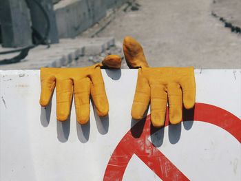 Close-up of yellow shoes on wall
