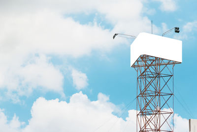 Low angle view of communications tower against sky