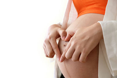 Close-up of hands over white background