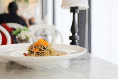 Close-up of pasta in plate on table