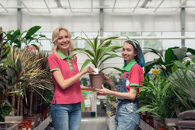 Midsection of woman holding potted plant