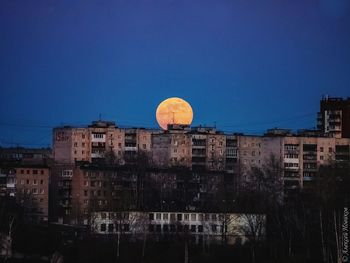 Low angle view of buildings against sky at night