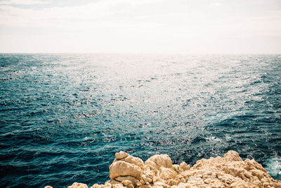 Scenic view of sea against sky on sunny day