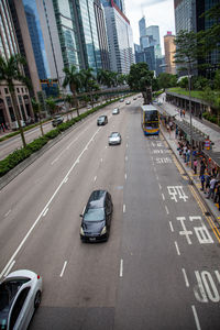 High angle view of vehicles on road amidst buildings in city