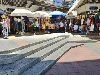 People at market stall in city