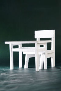 Figurine of chair and table on blackboard