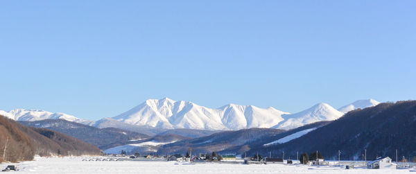 Scenic view of snowcapped mountains against clear sky