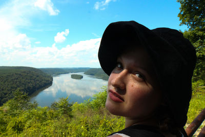 Portrait of boy looking away against sky