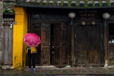 Woman standing by door