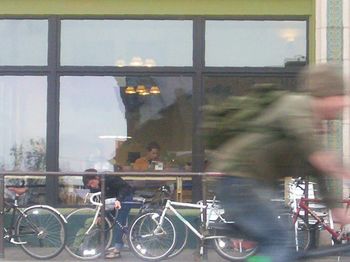 Bicycles in city against sky