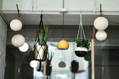 Close-up of illuminated lights hanging on ceiling at home