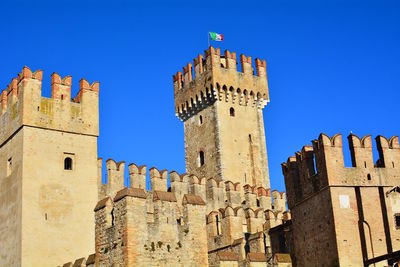 Low angle view of historic building against blue sky