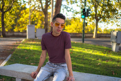 Full length of young man sitting on plant