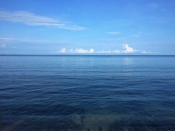 Scenic view of sea against blue sky