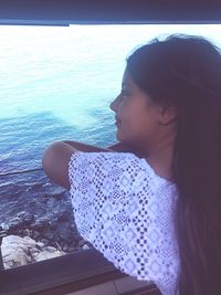 Close-up of young woman sitting at beach