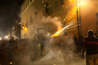 People walking on street at night