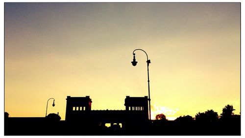 Low angle view of silhouette building against sky