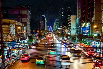 Illuminated cityscape against sky at night