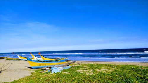 Scenic view of beach against blue sky