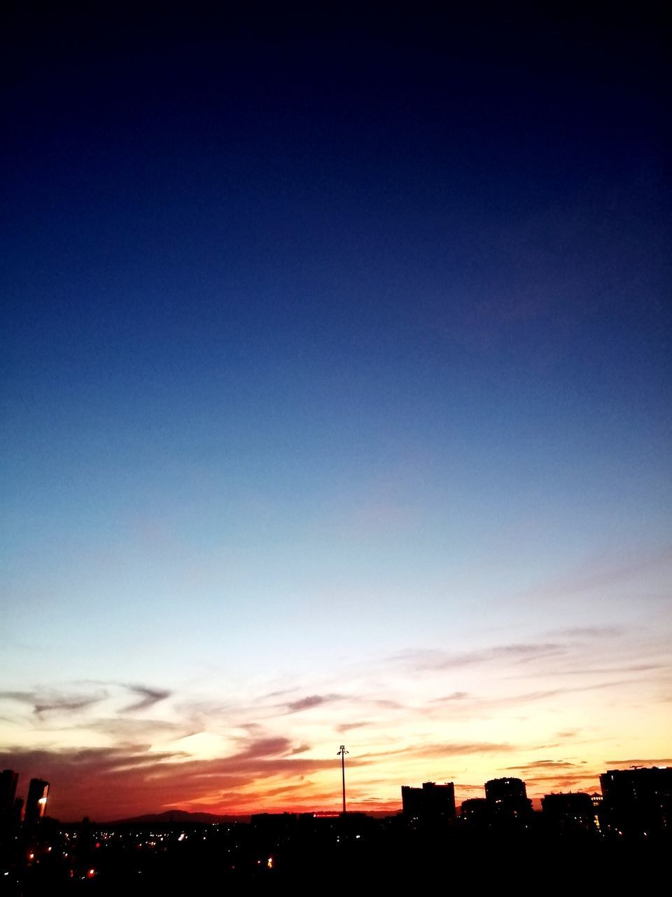 SILHOUETTE BUILDINGS AGAINST SKY DURING SUNSET