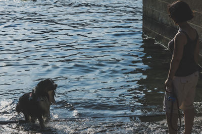 Young woman with dog in lake