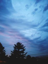 Low angle view of silhouette trees against sky at sunset