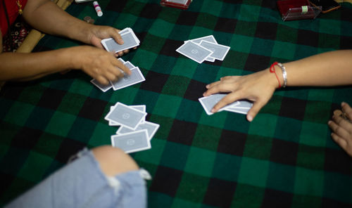 High angle view of people playing on table