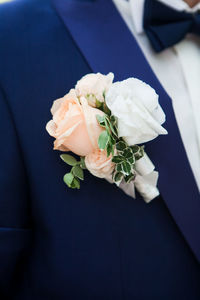 Midsection of man with flowers in blazer