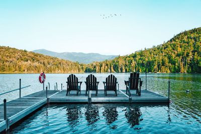 Scenic view of lake by mountains against clear sky