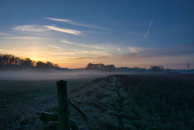 Scenic view of field against sky during sunset