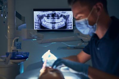 Dentist examining girl at clinic