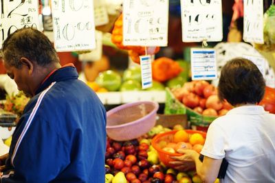 Rear view of fruits for sale at market stall